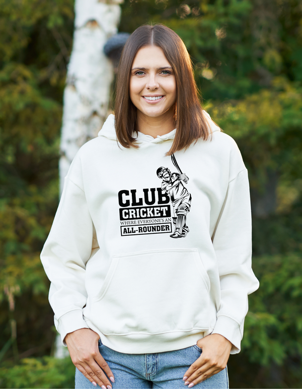 A lady wearing a white hoodie with Funny Cricket Hoodie – 'Club Cricket: Where Everyone’s an All-Rounder' on the front. A Funny Cricket Hoodie, Premium Fabric, Multiple Adult Sizes