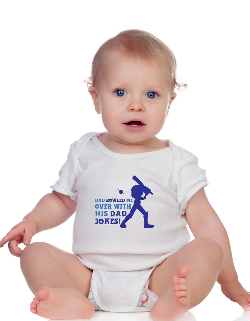 A baby wearing a baby grow with Dad Bowled Me over With His Dad Jokes, on the front! Funny Cricket Baby Bodysuit, Organic or In-Conversion to Organic Cotton, Self Fabric Bound Neckline, Cuffs and Leg Openings