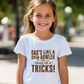 A little girl with wearing a Funny Cricket T-Shirt – "Dad’s Like a Spin Bowler, Always Full of Tricks, on the front". A Premium Fabric, Multiple Junior Sizes, Perfect for Boys and Girls
