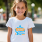 A little girl wearing a Funny Kids Cricket T-Shirt with “Dad Is a Great Fielder, Always Catching Me Out” on the front. Premium Fabric, Multiple Junior Sizes, Perfect for Boys and Girls