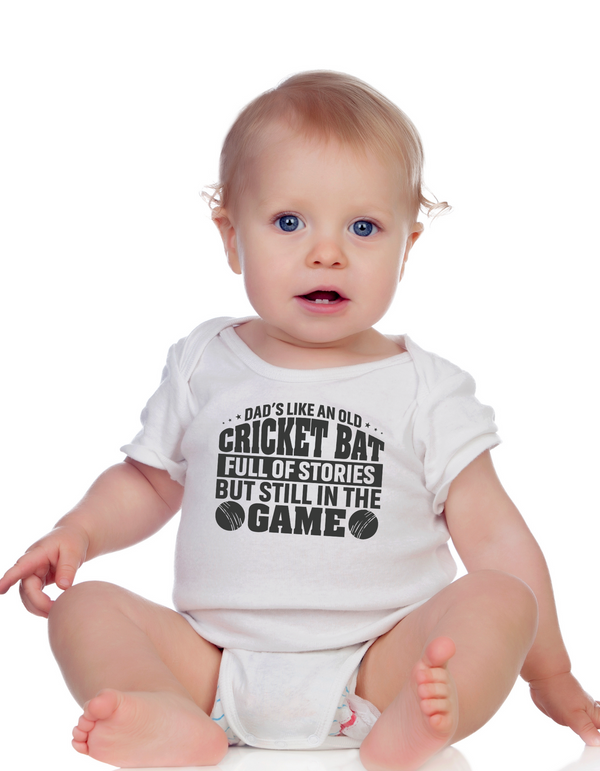 A baby wearing a baby grow with Dad’s Like an Old Cricket Bat, Full of Stories but Still in the Game - on the front! Funny Cricket Baby Bodysuit, Organic or In-Conversion to Organic Cotton, Self Fabric Bound Neckline, Cuffs and Leg Openings