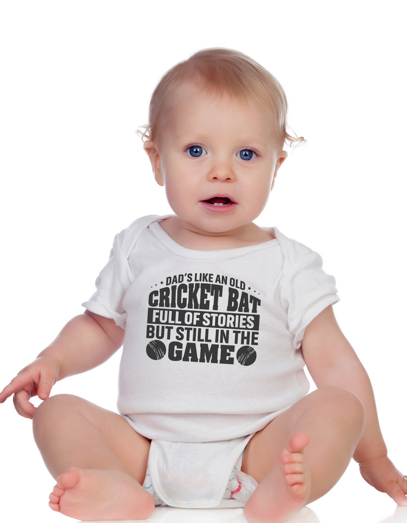 A baby wearing a baby grow with Dad’s Like an Old Cricket Bat, Full of Stories but Still in the Game - on the front! Funny Cricket Baby Bodysuit, Organic or In-Conversion to Organic Cotton, Self Fabric Bound Neckline, Cuffs and Leg Openings