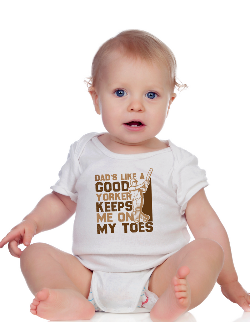 A baby wearing a baby grow with Dad’s Like a Good Yorker, Keeps Me on My Toes, on the front! Funny Cricket Baby Bodysuit, Organic or In-Conversion to Organic Cotton, Self Fabric Bound Neckline, Cuffs and Leg Openings
