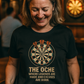 Woman wearing a black t-shirt with a dartboard design and text in a pub setting with a Cows Corner slogan The oche where legends are made and excuses are born.