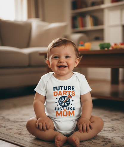 Child wearing a onesie with 'Future Darts Just Like Mum' text in a living room.  The baby is wearing a baby grow with the funny darts slogan 'Future Darts Star Just Like Mum'. Cows Corner gifts are perfect for sport-mad fans, these gifts work brilliantly for birthdays, new baby celebrations, Father’s Day, Mother’s Day, Christmas, anniversaries, thank you gifts, end-of-season team awards, graduations, retirements, and just-because moments when you want to raise a smile. 
