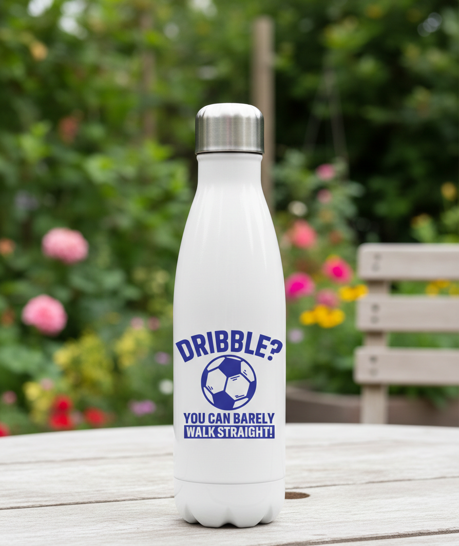 White water bottle with blue text and a soccer ball graphic on a wooden table with a garden background. This is a Cows Corner water bottle with a funny football slogan 'Dribble You Can Barely Walk Straight!'. Cows Corner gifts are perfect for sport-mad fans, these gifts work brilliantly for birthdays, new baby celebrations, Father’s Day, Mother’s Day, Christmas, anniversaries, thank you gifts, end-of-season team awards, graduations, retirements, and just-because moments when you want to raise a smile. 
