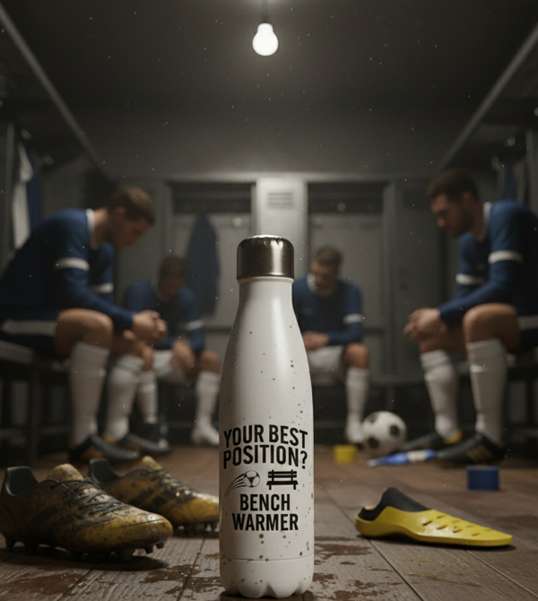 White insulated bottle with text in a sports changing room.  White water bottle with text on a sports field. Cows Corner funny birthday present water bottle with funny slogan 'your best position?  Bench warmer!  Cows Corner gifts are perfect for sport-mad fans, these gifts work brilliantly for birthdays, new baby celebrations, Father’s Day, Mother’s Day, Christmas, anniversaries, thank you gifts, end-of-season team awards, graduations, retirements, and just-because moments when you want to raise a smile. 