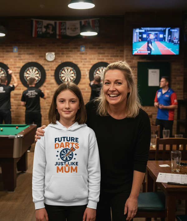 Woman and young girl standing together in a bar with dartboards and a pool table in the background.  The girl is wearing a Cows Corner hoodie with a funny darts slogan that reads 'Future Darts Star Just Like Mum'.  Cows Corner gifts are perfect for sport-mad fans, these gifts work brilliantly for birthdays, new baby celebrations, Father’s Day, Mother’s Day, Christmas, anniversaries, thank you gifts, end-of-season team awards, graduations, retirements, and just-because moments when you want to raise a smile.