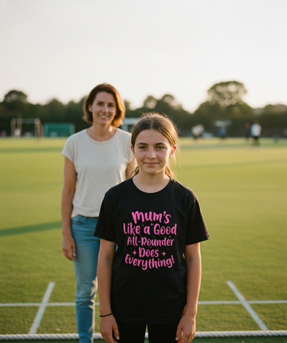 Girl wearing a black t-shirt with pink text on a sports field with a woman in the background. The girl is wearing a Cows Corner t-shirt with the funny cricket slogan 'Mums Like A Good All-rounder, Does Everything'. Cows Corner gifts are perfect for sport-mad fans, these gifts work brilliantly for birthdays, new baby celebrations, Father’s Day, Mother’s Day, Christmas, anniversaries, thank you gifts, end-of-season team awards, graduations, retirements, and just-because moments when you want to raise a smile.