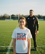Person wearing a t-shirt with 'Dad's my hero on and off the pitch' on a sports field. The girl is wearing a Cows Corner t-shirt with the funny rugby slogan 'Dad’s My Hero on and off the Pitch!'. Cows Corner gifts are perfect for sport-mad fans, these gifts work brilliantly for birthdays, new baby celebrations, Father’s Day, Mother’s Day, Christmas, anniversaries, thank you gifts, end-of-season team awards, graduations, retirements, and just-because moments when you want to raise a smile. 
