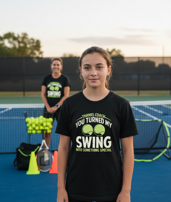 Girl wearing a black t-shirt on a tennis court with another person in the background. The girl is wearing a Cows Corner t-shirt with the funny golf slogan 'Thanks Coach You Turned My Swing Into Something Special'. Cows Corner gifts are perfect for sport-mad fans, these gifts work brilliantly for birthdays, new baby celebrations, Father’s Day, Mother’s Day, Christmas, anniversaries, thank you gifts, end-of-season team awards, graduations, retirements, and just-because moments when you want to raise a smile. 