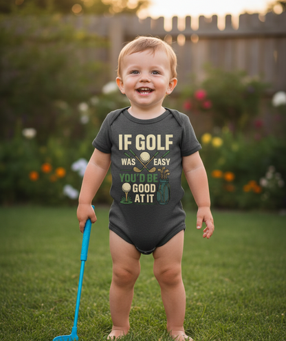 Child wearing a humorous golf-themed onesie in a garden setting. The baby is wearing a Cows Corner baby grow with a funny golf slogan 'If Golf Was Easy You’d Be Good at It'. Cows Corner gifts are perfect for sport-mad fans, these gifts work brilliantly for birthdays, new baby celebrations, Father’s Day, Mother’s Day, Christmas, anniversaries, thank you gifts, end-of-season team awards, graduations, retirements, and just-because moments when you want to raise a smile. 
