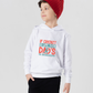 A little boy wearing a white hoodie with If Cricket Is Life, Then Dad's The Groundskeeper on the front. A Funny Cricket Hoodie, Premium Fabric, Multiple Junior Sizes, Perfect for Boys and Girls