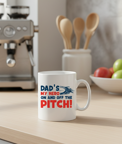 This is a Cows Corner mug with a funny rugby slogan 'Dad’s My Hero on and off the Pitch!'  Cows Corner gifts are perfect for sport-mad fans, these gifts work brilliantly for birthdays, new baby celebrations, Father’s Day, Mother’s Day, Christmas, anniversaries, thank you gifts, end-of-season team awards, graduations, retirements, and just-because moments when you want to raise a smile. 
