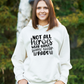 A lady wearing a white hoodie with Not All Heroes Wear Capes, Some Wear Pads on the front. A Funny Cricket Hoodie, Premium Fabric, Multiple Adult Sizes