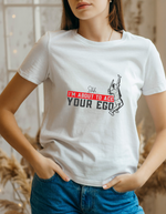 A lady wearing a white t-shirt with a funny tennis slogan on the front that reads 'Shh....i'm About To Ace Your Ego'