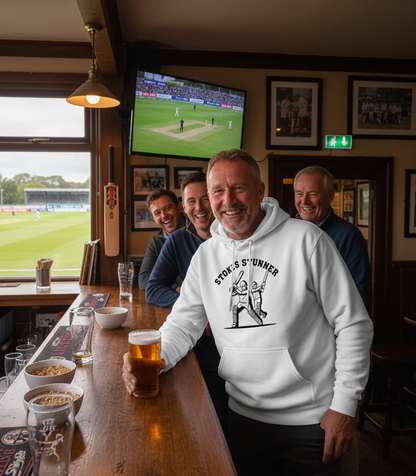 Men in a pub watching cricket on television, one holding a beer. The man is wearing a Cows Corner hoodie with the funny cricket slogan that reads 'Stokes Stunner'. Cows Corner gifts are perfect for sport-mad fans, these gifts work brilliantly for birthdays, new baby celebrations, Father’s Day, Mother’s Day, Christmas, anniversaries, thank you gifts, end-of-season team awards, graduations, retirements, and just-because moments when you want to raise a smile. 
