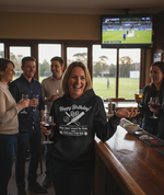 A lady wearing a Cows Corner hoodie with the funny cricket birthday slogan 'Happy Birthday! May your wood be firm and your balls stay red.'. Cows Corner gifts are perfect for sport-mad fans, these gifts work brilliantly for birthdays, new baby celebrations, Father’s Day, Mother’s Day, Christmas, anniversaries, thank you gifts, end-of-season team awards, graduations, retirements, and just-because moments when you want to raise a smile. 
