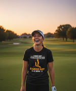 Woman on a golf course wearing a t-shirt with a humorous quote. The lady is wearing a Cows Corner t-shirt with the funny golf slogan 'A Bad Day at Golf Is Better Than a Good Day at Work'. Cows Corner gifts are perfect for sport-mad fans, these gifts work brilliantly for birthdays, new baby celebrations, Father’s Day, Mother’s Day, Christmas, anniversaries, thank you gifts, end-of-season team awards, graduations, retirements, and just-because moments when you want to raise a smile. 
