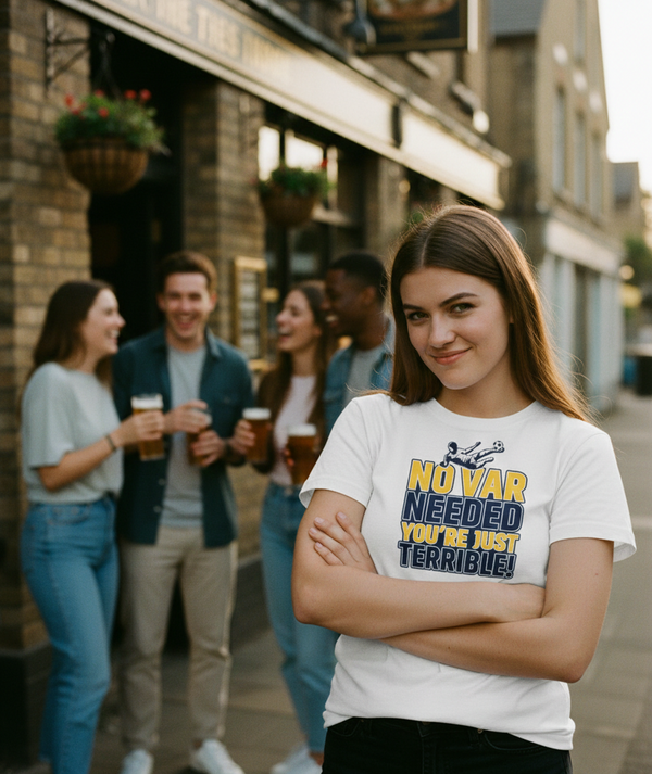 Woman wearing a t-shirt with humorous text in an urban setting with friends. The lady is wearing a Cows Corner t-shirt with the funny football slogan 'No VAR Needed You’re Just Terrible'. Cows Corner gifts are perfect for sport-mad fans, these gifts work brilliantly for birthdays, new baby celebrations, Father’s Day, Mother’s Day, Christmas, anniversaries, thank you gifts, end-of-season team awards, graduations, retirements, and just-because moments when you want to raise a smile. 
