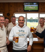 Group of men in a pub, one wearing a hoodie with text, all holding drinks. The man is wearing a Cows Corner hoodie with a funny cricket slogan that reads 'Swing both ways, only if its reverse'.  Cows Corner gifts are perfect for sport-mad fans, these gifts work brilliantly for birthdays, new baby celebrations, Father’s Day, Mother’s Day, Christmas, anniversaries, thank you gifts, end-of-season team awards, graduations, retirements, and just-because moments when you want to raise a smile. 
