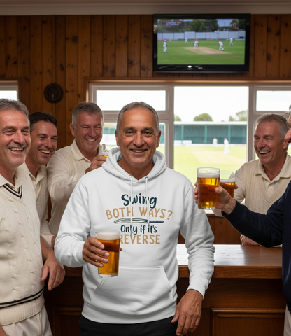 Group of men in a pub, one wearing a hoodie with text, all holding drinks. The man is wearing a Cows Corner hoodie with a funny cricket slogan that reads 'Swing both ways, only if its reverse'.  Cows Corner gifts are perfect for sport-mad fans, these gifts work brilliantly for birthdays, new baby celebrations, Father’s Day, Mother’s Day, Christmas, anniversaries, thank you gifts, end-of-season team awards, graduations, retirements, and just-because moments when you want to raise a smile. 
