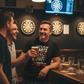 Three men in a bar, two of whom are holding drinks, with dartboards on the wall. The man is wearing a Cows Corner t-shirt with a funny darts slogan on the front that reads 'Lets Play Darts I'll Show You My Best Shaft Work'. Cows Corner gifts are perfect for sport-mad fans, these gifts work brilliantly for birthdays, new baby celebrations, Father’s Day, Mother’s Day, Christmas, anniversaries, thank you gifts, end-of-season team awards, graduations, retirements, and just-because moments when you want to raise