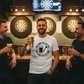 Three men in a bar with drinks, smiling and posing for a photo in front of dartboards. The man is wearing a Cows Corner t-shirt with the funny darts slogan 'One Hand For The Pint, One Hand For The Darts'. Cows Corner gifts are perfect for sport-mad fans, these gifts work brilliantly for birthdays, new baby celebrations, Father’s Day, Mother’s Day, Christmas, anniversaries, thank you gifts, end-of-season team awards, graduations, retirements, and just-because moments when you want to raise a smile. 

