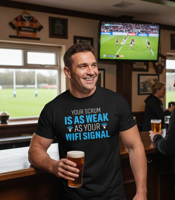 Man in a pub wearing a humorous t-shirt holding a beer, with a sports event on TV in the background. The man is wearing a Cows Corner t-shirt with the funny rugby slogan on the front that reads 'Your Scrum Is As Weak as Your WiFi Signal'. Cows Corner gifts are perfect for sport-mad fans, these gifts work brilliantly for birthdays, new baby celebrations, Father’s Day, Mother’s Day, Christmas, anniversaries, thank you gifts, end-of-season team awards, graduations, retirements, and just-because moments