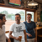 Three men in a bar watching a tennis match on TV, one holding a beer.  The man is wearing a Cows Corner T-shirt with the funny tennis slogan on the front that reads 'This Court Ain't Big Enough For Your Excuses'. Cows Corner gifts are perfect for sport-mad fans, these gifts work brilliantly for birthdays, new baby celebrations, Father’s Day, Mother’s Day, Christmas, anniversaries, thank you gifts, end-of-season team awards, graduations, retirements, and just-because moments when you want to raise a smile. 