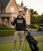 Man holding a golf club and wearing a hoodie with text on a golf course.  The man is wearing a Cows Corner hoodie with a funny golf slogan 'The Best Wood in Most Amateurs Bags, Is the Pencil'. Cows Corner gifts are perfect for sport-mad fans, these gifts work brilliantly for birthdays, new baby celebrations, Father’s Day, Mother’s Day, Christmas, anniversaries, thank you gifts, end-of-season team awards, graduations, retirements, and just-because moments when you want to raise a smile. 
