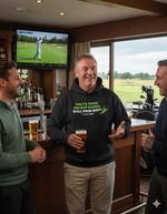 Three men in a bar watching golf on TV with one man in a hoodie holding a beer. The man is wearing a Cows Corner hoodie with a funny golf slogan 'Golf’s There Ugliest Words: ’Still Your Shot! – Dave Marr'. Cows Corner gifts are perfect for sport-mad fans, these gifts work brilliantly for birthdays, new baby celebrations, Father’s Day, Mother’s Day, Christmas, anniversaries, thank you gifts, end-of-season team awards, graduations, retirements, and just-because moments when you want to raise a smile. 
