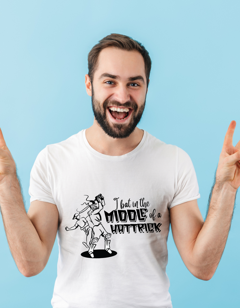 A man wearing a white t-shirt with "I Bat In The Middle Of A Hattrick" A Funny Cricket T-shirt, Premium Fabric, Multiple Adult Sizes