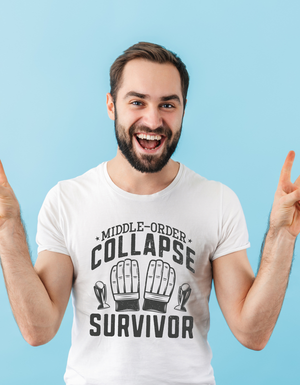 A man wearing a white t-shirt with Middle-order Collapse Survivor on the front.  A Funny Cricket T-shirt, Premium Fabric, Multiple Adult Sizes