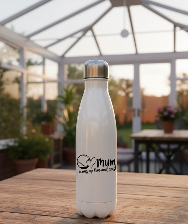 A white Cows Corner water bottle with 'mum serves up love and joy' text on a wooden table with a blurred garden background. Cows Corner gifts are perfect for sport-mad fans, these gifts work brilliantly for birthdays, new baby celebrations, Father’s Day, Mother’s Day, Christmas, anniversaries, thank you gifts, end-of-season team awards, graduations, retirements, and just-because moments when you want to raise a smile. 

