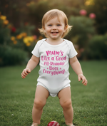 Child wearing a white onesie with pink text in an outdoor setting. The baby is wearing a Cows Corner baby grow with the funny cricket slogan 'Mums Like A Good All-rounder, Does Everything'. Cows Corner gifts are perfect for sport-mad fans, these gifts work brilliantly for birthdays, new baby celebrations, Father’s Day, Mother’s Day, Christmas, anniversaries, thank you gifts, end-of-season team awards, graduations, retirements, and just-because moments when you want to raise a smile. 
