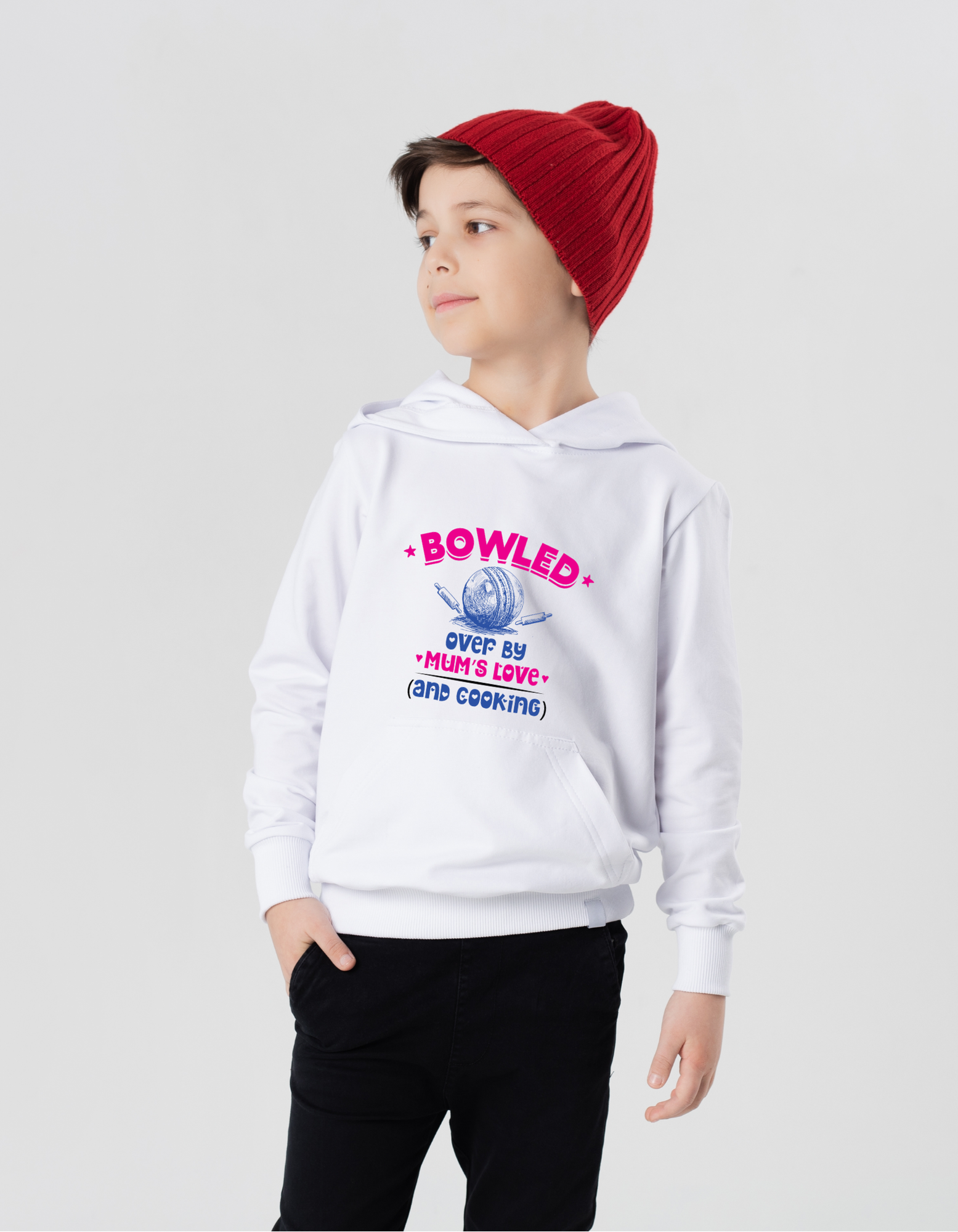 A little boy wearing a white hoodie with Bowled Over by Mum’s Love (and Cooking) on the front.  A Funny Cricket Hoodie, Premium Fabric, Multiple Junior Sizes, Perfect for Boys and Girls