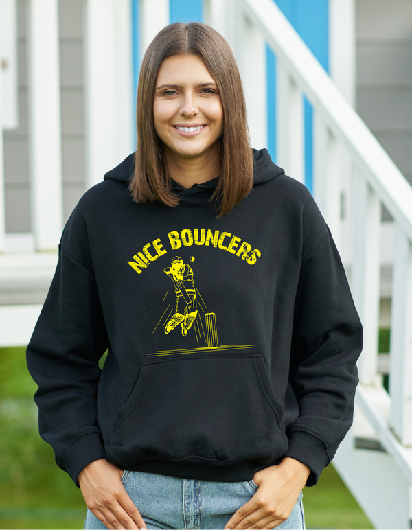 A lady wearing a black hoodie with Nice Bouncers on the front. A Funny Cricket Hoodie, Premium Fabric, Multiple Adult Sizes