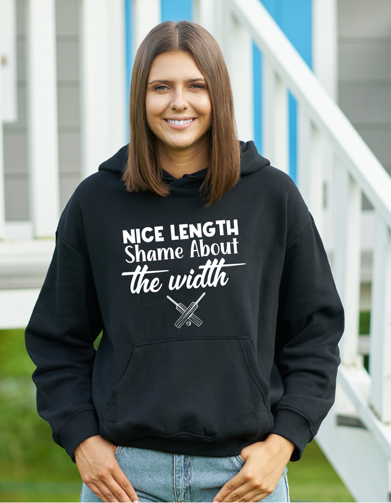A lady wearing a black hoodie with Nice Length, Shame About The Width on the front. A Funny Cricket Hoodie, Premium Fabric, Multiple Adult Sizes