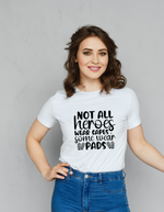 A lady wearing a white t-shirt with Not All Heroes Wear Capes, Some Wear Pads on the front. A Funny Cricket T-shirt, Premium Fabric, Multiple Adult Sizes