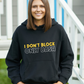 A lady wearing a black hoodie with I Don't Block Only Bash on the front!   A Funny Cricket Hoodie, Premium Fabric, Multiple Adult Sizes