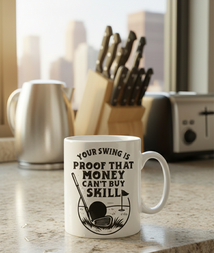 White mug with golf-themed design and text in a kitchen setting. This is a Cows Corner mug with the funny golf slogan 'Your Swing Is Proof That Money Can’t Buy Skill'. Cows Corner gifts are perfect for sport-mad fans, these gifts work brilliantly for birthdays, new baby celebrations, Father’s Day, Mother’s Day, Christmas, anniversaries, thank you gifts, end-of-season team awards, graduations, retirements, and just-because moments when you want to raise a smile. 
