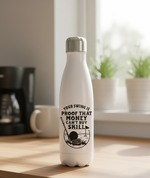 White water bottle with motivational quote on a wooden surface. This is a Cows Corner water bottle with a funny golf slogan 'Your Swing Is Proof That Money Can’t Buy Skill'. Cows Corner gifts are perfect for sport-mad fans, these gifts work brilliantly for birthdays, new baby celebrations, Father’s Day, Mother’s Day, Christmas, anniversaries, thank you gifts, end-of-season team awards, graduations, retirements, and just-because moments when you want to raise a smile. 
