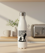 White water bottle with a motivational quote on a kitchen counter. This is a Cows Corner water bottle with a funny rugby slogan 'You Taught Me More Than Rugby, You Taught Me Resilience. Thank You, Coach'. Cows Corner gifts are perfect for sport-mad fans, these gifts work brilliantly for birthdays, new baby celebrations, Father’s Day, Mother’s Day, Christmas, anniversaries, thank you gifts, end-of-season team awards, graduations, retirements, and just-because moments when you want to raise a smile. 
