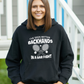 A a lady wearing black hoodie with the funny tennis slogan on the front that reads 'I've Seen Better Backhands In A Bar Fight'