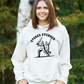 A lady wearing a white hoodie with Stokes Stunner, on the front. A Funny Cricket Hoodie, Premium Fabric, Multiple Adult Sizes