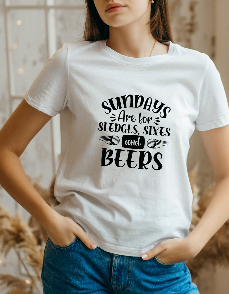 A lady wearing a white t-shirt with Sundays Are for Sledges, Sixes, and Beers on the front.  A funny Cricket T-Shirt, Premium Fabric, Multiple Adult Sizes