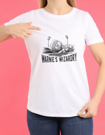 A lady wearing a white t-shirt with Warnie’s Wizardry on the front.  A Funny Cricket T-Shirt. Premium Fabric, Multiple Adult Sizes