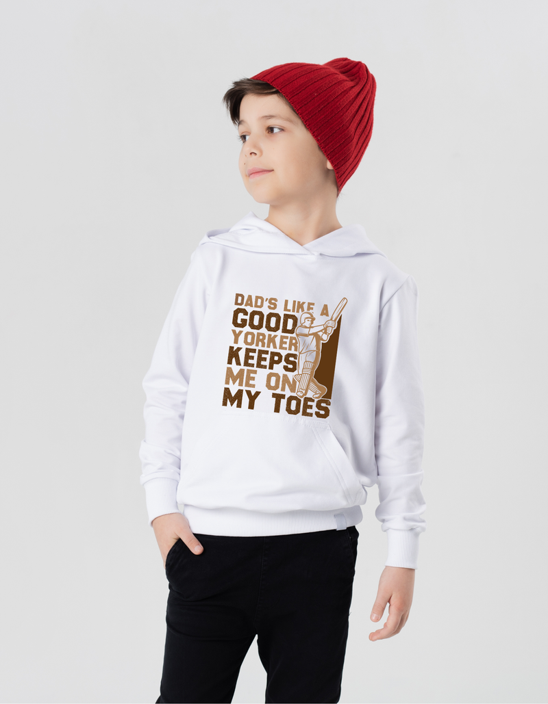 A little boy wearing a white hoodie with Dad’s Like a Good Yorker, Keeps Me on My Toes, on the front!  Funny Cricket Hoodie, Premium Fabric, Multiple Adult Sizes