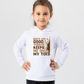 A little girl wearing a white hoodie with Dad’s Like a Good Yorker, Keeps Me on My Toes, on the front!  Funny Cricket Hoodie, Premium Fabric, Multiple Adult Sizes